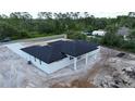 Aerial view of the home showing the back patio and the surrounding wooded landscape at 40327 Royal Trails Rd, Eustis, FL 32736
