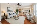 Bright living room featuring hardwood floors, modern furnishings, and an open floor plan at 9417 Se 132Nd Loop, Summerfield, FL 34491