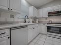 Bright, updated kitchen featuring white cabinets, appliances, tile backsplash and countertops at 3360 Richmond Dr, The Villages, FL 32162