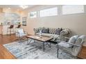 Stylish living room features a neutral color scheme, hardwood floors, and ample natural light at 5441 Sea Leopard St, Tavares, FL 32778