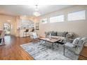 Well-lit living room featuring modern furniture, hardwood floors, and an open layout to the kitchen at 5441 Sea Leopard St, Tavares, FL 32778