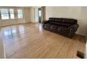 Spacious living room features wood floors, ample natural light, and sliding glass doors to the exterior at 101 Poinsettia Cv, Leesburg, FL 34748
