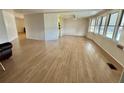Bright and open living space showcasing wood floors, with windows and views of the surrounding neighborhood at 101 Poinsettia Cv, Leesburg, FL 34748