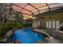 Enclosed backyard pool featuring rock accents, a patio, and lots of space to relax at 10417 Lake Louisa Rd, Clermont, FL 34711