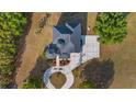 Top-down view of the beautiful roofline and circular driveway of the home with mature landscaping at 10651 Arrowtree Blvd, Clermont, FL 34715