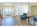 Open living space with high ceilings, a ceiling fan, wood flooring, and views of the front entryway at 1101 Saldivar Rd, The Villages, FL 32159