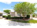 Beautiful home featuring a beige exterior, lush landscaping, and a cozy feel at 1135 Easley Way, The Villages, FL 32162