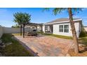 Private backyard with a brick patio, pergola, and a serene outdoor space for relaxation and entertainment at 118 Green Branch Blvd, Groveland, FL 34736