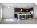 Open-concept kitchen with stainless steel appliances, mosaic tile backsplash, and ample counter space at 118 Green Branch Blvd, Groveland, FL 34736