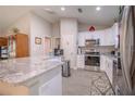 Well-lit kitchen with stainless steel appliances, granite countertops, and white cabinetry at 13662 Se 55Th Ave, Summerfield, FL 34491