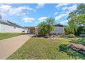 Inviting home with carport and lush landscaping creating a welcoming exterior at 1541 Doral Cir, Lady Lake, FL 32159