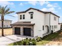 Two-story home boasting a stone-accented garage, black trimmed windows, and neatly landscaped yard at 16028 Trivoli Cir, Montverde, FL 34756