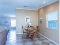 Cozy dining area features a table set for four, with elegant decor and a view into the living area at 1723 Morelos Rd, The Villages, FL 32159