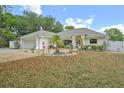 Charming single-story home with a well-manicured front yard and attached two-car garage at 202 N Palm Ave, Howey In The Hills, FL 34737