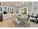 Elegant dining area with a stylish table, modern chairs, and built-in cabinets at 207 Hawthorne Blvd, Leesburg, FL 34748
