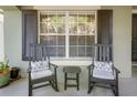 Inviting front porch with rocking chairs, perfect for relaxing and enjoying the outdoors at 20816 Sullivan Ranch Blvd, Mount Dora, FL 32757