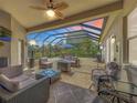 Spacious screened lanai with comfortable seating and views of the meticulously landscaped backyard at 25545 Laurel Valley Rd, Leesburg, FL 34748