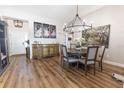 Open concept dining room with round table, stylish decor, and wood-look floors at 3273 Dzuro Dr, Oxford, FL 34484