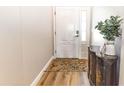 Inviting foyer featuring a decorative rug on wood floors, a console table, and a sidelight window at 3273 Dzuro Dr, Oxford, FL 34484