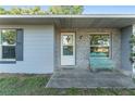 Inviting front porch with a decorative bench, stylish brickwork, and well-maintained landscaping at 36337 Terra Ct, Grand Island, FL 32735