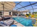 Relaxing screened-in pool area with chaise lounges, patio set and sparkling pool at 3641 Arlington Ridge Blvd, Leesburg, FL 34748
