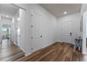 Entryway with wood-look floors, white walls and doors, and views into other rooms at 4131 Sunset Preserve Blvd, Orlando, FL 32820
