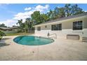Relaxing Kidney-shaped pool with a light concrete deck perfect for enjoying the outdoors at 5331 Magnolia Ridge Rd, Fruitland Park, FL 34731