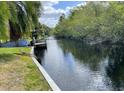 Scenic view of the canal, featuring lush greenery and a small dock, perfect for waterfront enjoyment at 5331 Magnolia Ridge Rd, Fruitland Park, FL 34731
