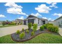 Beautiful home showcasing lush landscaping and a well-manicured lawn at 5549 Millican Ave, The Villages, FL 32163