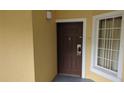 Condominium front door, showing electronic lock and large picture window at 8801 Worldquest Blvd # 4203, Orlando, FL 32821