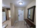 Hallway featuring mirror and table, leading to kitchen with white refrigerator at 8801 Worldquest Blvd # 4203, Orlando, FL 32821