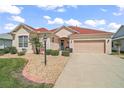 Attractive single-story home featuring a neatly landscaped yard and a welcoming entrance at 971 Caribou Way, The Villages, FL 32162
