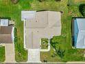 Aerial view of the home showing the roof, green backyard, patterned driveway, and white pergola at 9773 Se 179Th Pl, Summerfield, FL 34491