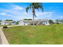 A well-maintained lawn and landscaping highlight this single-story home with a 2 car garage at 9773 Se 179Th Pl, Summerfield, FL 34491