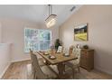 Cozy dining room featuring chandelier, wood table, and window at 10257 Dovehill Ln, Clermont, FL 34711
