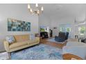 Bright living room featuring vaulted ceilings, modern lighting, and stylish decor at 11497 Sw 82Nd Court Rd, Ocala, FL 34481