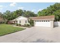 Exterior view of a home showing a large two car garage and spacious driveway at 1202 Bly Ct, Eustis, FL 32726