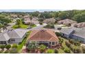 Aerial view of a house showcasing the roof, backyard, and surrounding neighborhood at 1210 Weaton Ct, The Villages, FL 32162