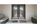 Inviting covered entry with double doors, accent seating, and welcome mats at 1210 Weaton Ct, The Villages, FL 32162