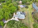 Expansive aerial view of the home, highlighting its large lot, screened lanai and lush landscaping at 13112 Luntz Point Ln, Windermere, FL 34786