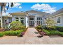 Beautiful front entrance with double doors and professionally landscaped yard at 13112 Luntz Point Ln, Windermere, FL 34786