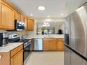 Well-lit kitchen boasting stainless steel appliances and ample counter space at 1561 Loris Loop, The Villages, FL 32162