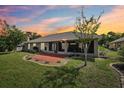 Expansive backyard showcasing a screened lanai and patio, perfect for outdoor entertaining at 179 Patrice Hope St, Leesburg, FL 34748