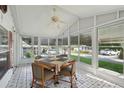 Inviting sunroom with tile floors, ceiling fan, and an abundance of natural light at 1901 Brookside Dr, Mount Dora, FL 32757