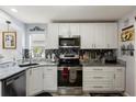 Modern kitchen featuring stainless steel appliances and stylish backsplash at 1917 Peachtree Ave, The Villages, FL 32162