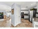Modern kitchen with stainless steel appliances, granite countertops, and adjacent dining area with chandelier at 1917 Peachtree Ave, The Villages, FL 32162