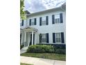 Charming townhome featuring a classic facade with black shutters and decorative columns at 2261 Osprey Ave, Orlando, FL 32814