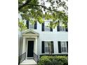 Charming townhome featuring a classic facade with black shutters and decorative columns at 2261 Osprey Ave, Orlando, FL 32814