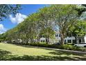 Scenic view of the community featuring manicured lawns, mature trees, and charming townhomes at 2261 Osprey Ave, Orlando, FL 32814