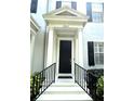 Inviting entrance with black front door, columns, and decorative stairs at 2261 Osprey Ave, Orlando, FL 32814